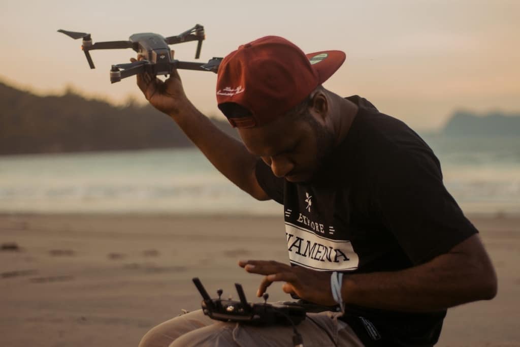 Young man holding drone - Drone Licence FAQs